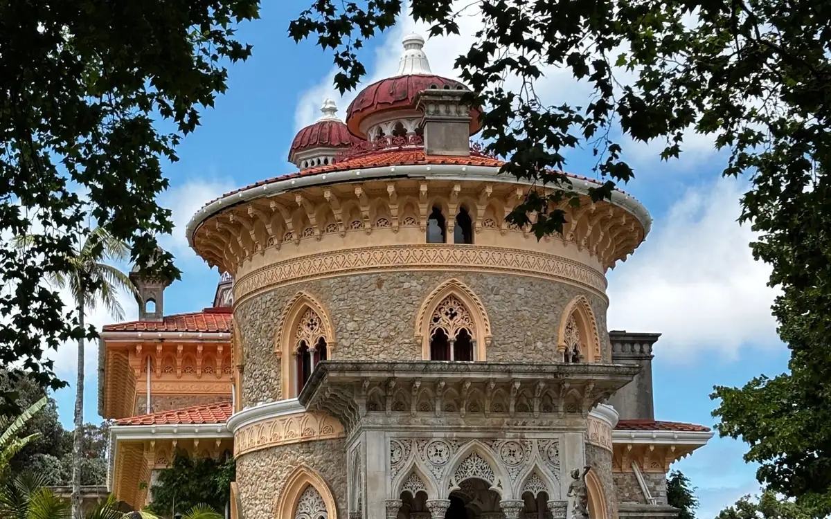 Der runde Steinturm und die rote Kuppel des Monserrate-Palasts, umrahmt von Bäumen